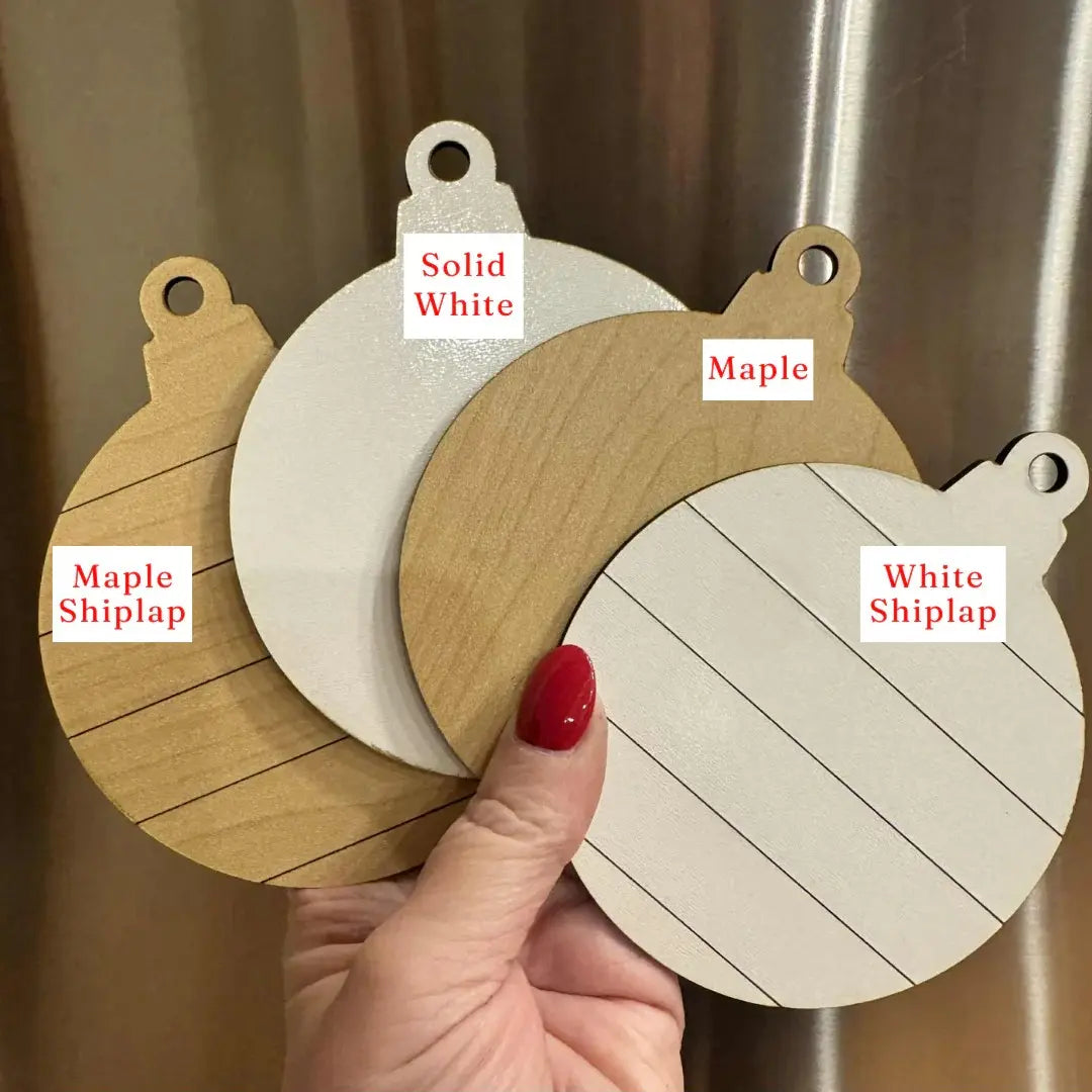 Three wooden samples labeled 'Solid White', 'Maple', and 'White Shiplap' held by a hand.