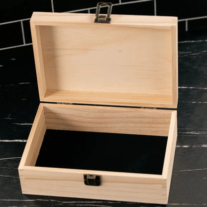 Wooden jewelry box with a black interior on a dark surface