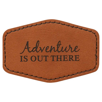 Brown leather patch with 'Adventure is Out There' text on a white background