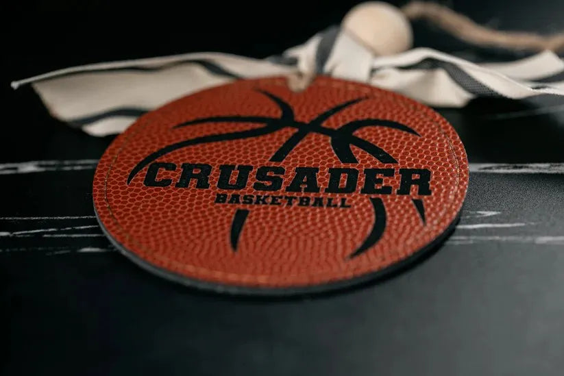 Basketball with 'Crusader Basketball' branding on a dark surface