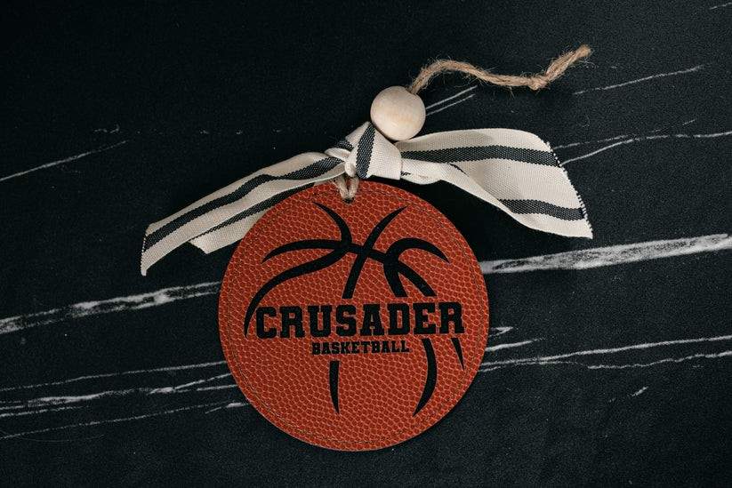 Decorative ornament with 'Crusader Basketball' text on a black background