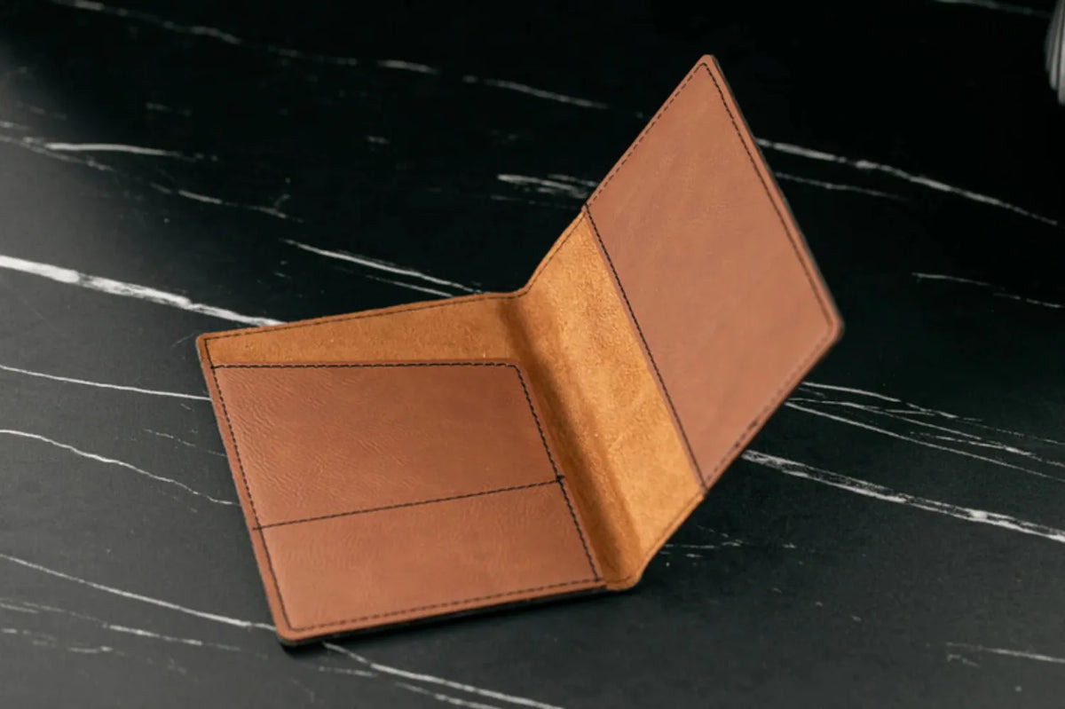 Brown leather wallet on a black marble surface